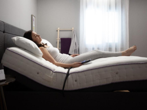 Woman sleeping comfortably on an adjustable bed.