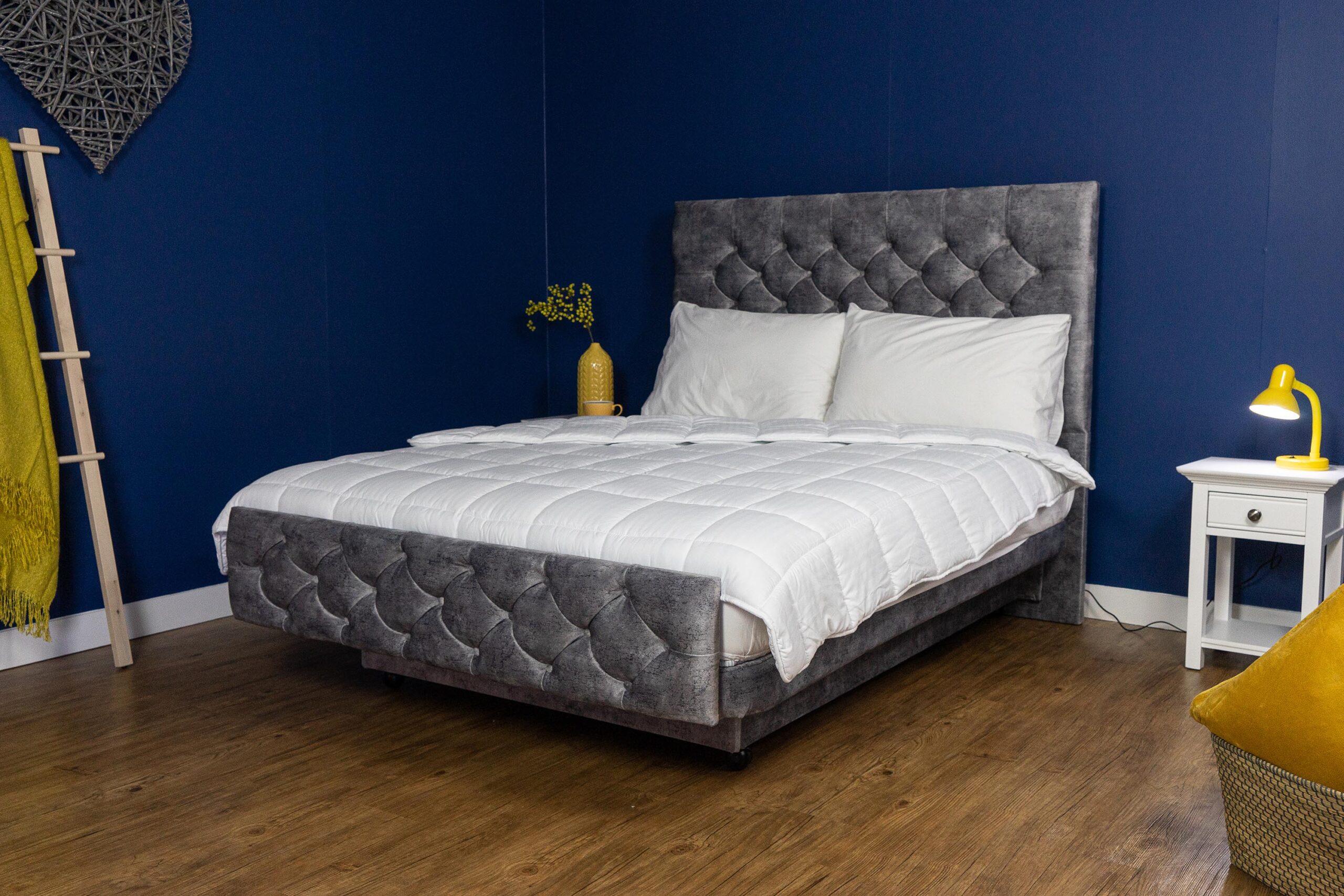 The Heritage Chatsworth Adjustable Bed in grey fabric with buttoned a headboard.